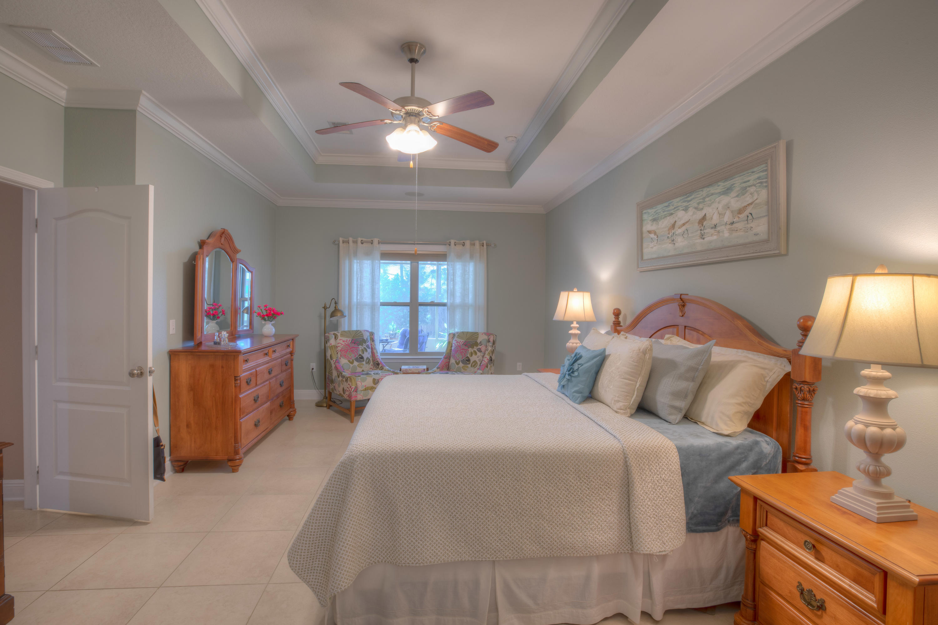 456 Pin Oak Loop Santa Rosa Beach, FL 32459 - Photo 22 of 32 a bedroom with a bed and a chandelier