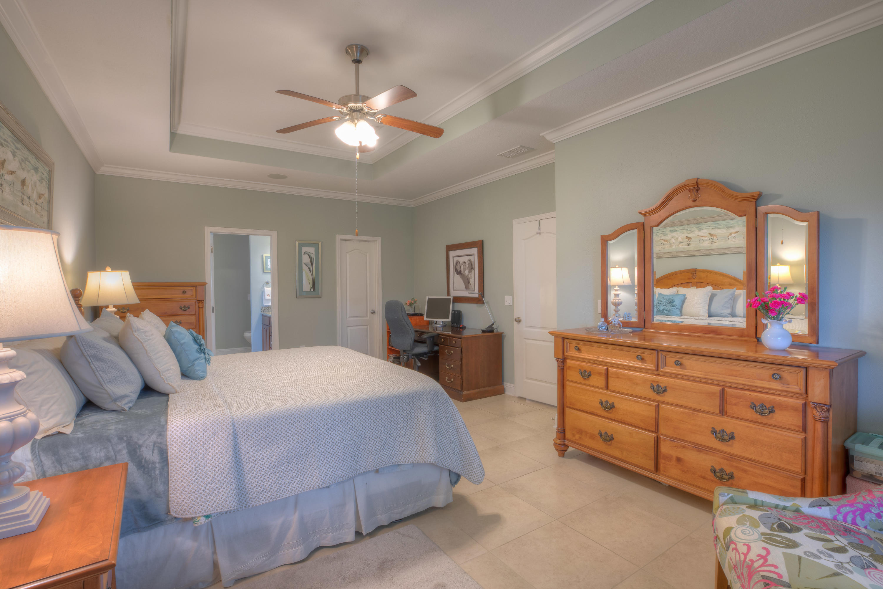 456 Pin Oak Loop Santa Rosa Beach, FL 32459 - Photo 23 of 32 a bedroom with a large bed and a chandelier