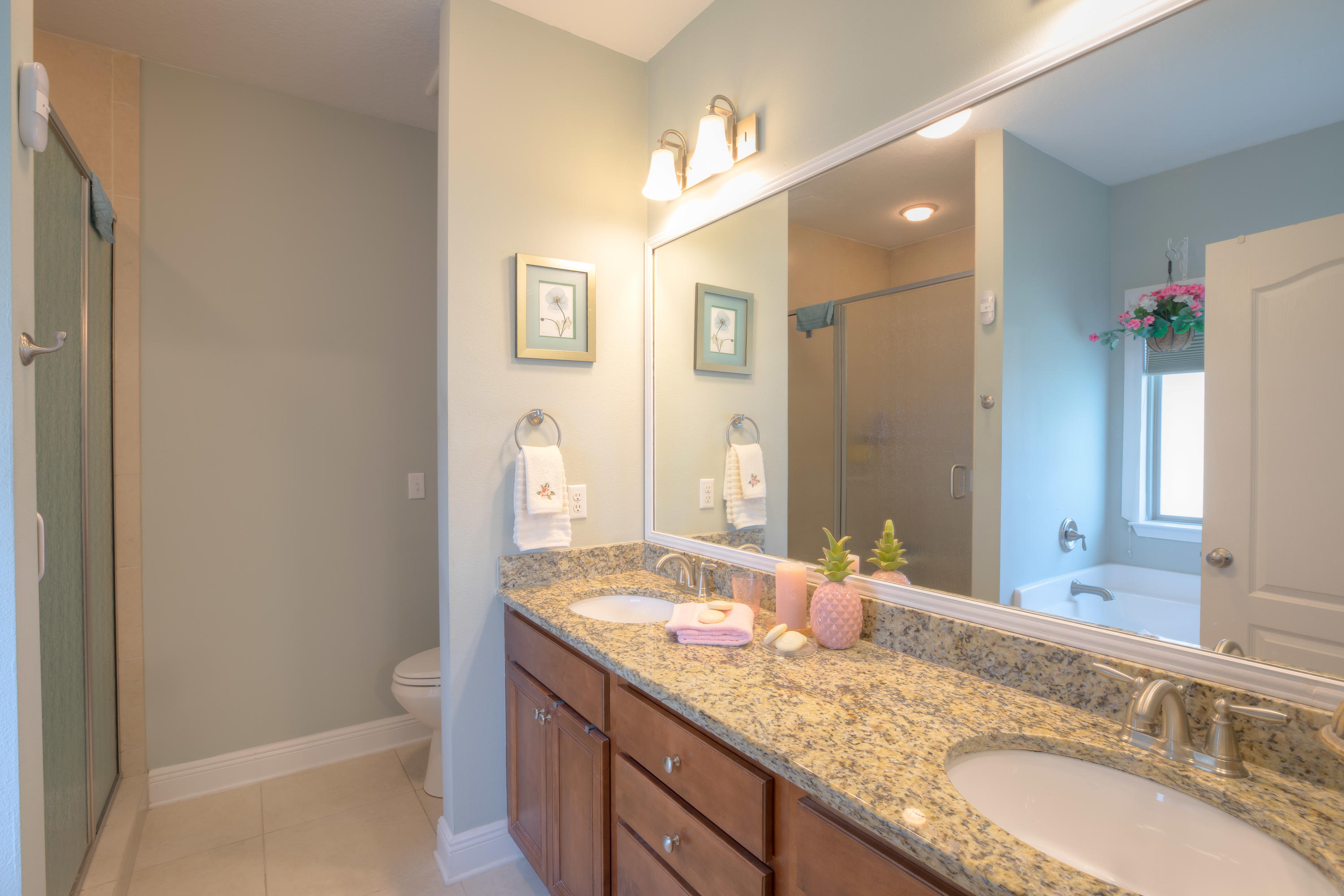 456 Pin Oak Loop Santa Rosa Beach, FL 32459 - Photo 24 of 32 a bathroom with a granite countertop sink double mirror and a