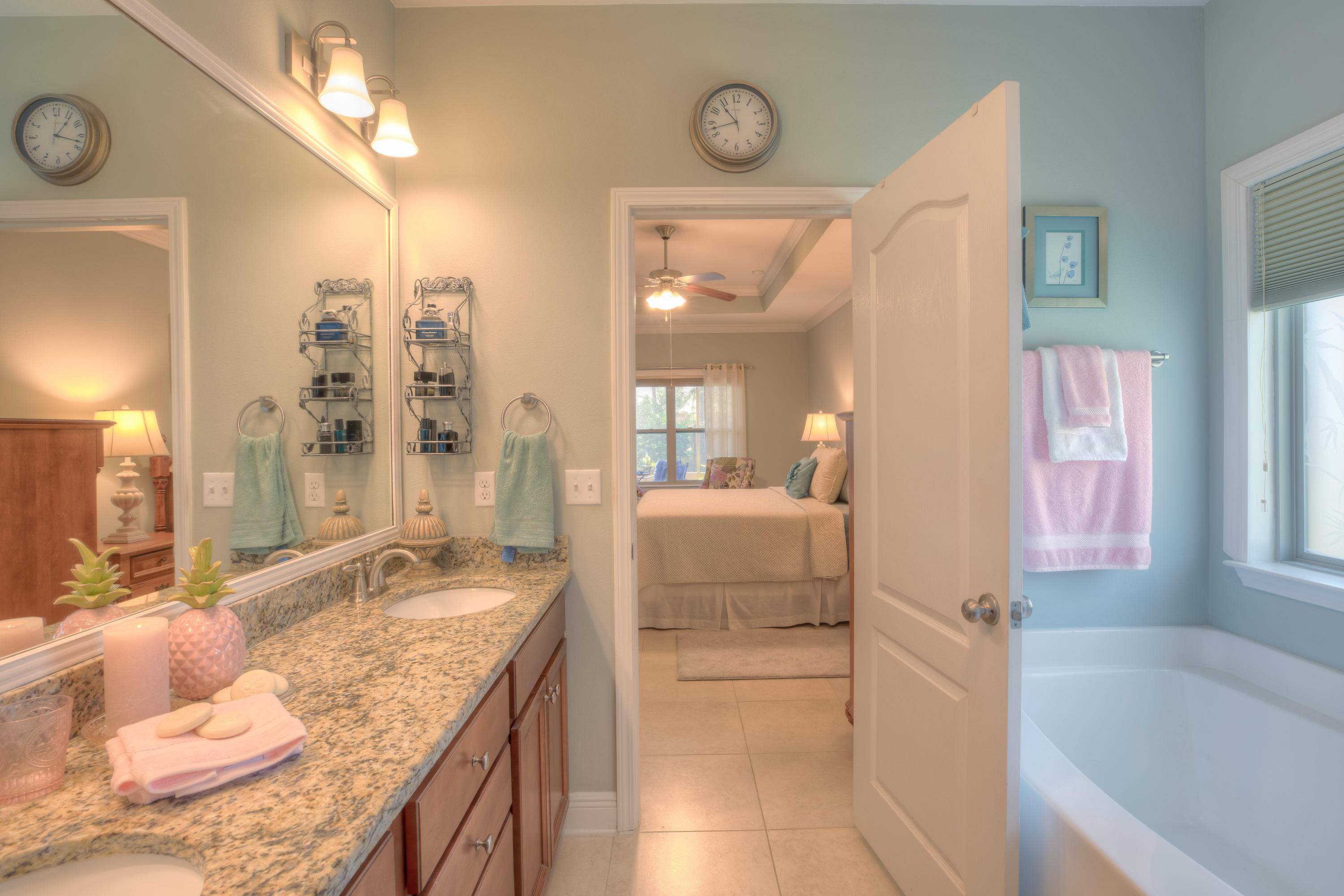 456 Pin Oak Loop Santa Rosa Beach, FL 32459 - Photo 25 of 32 a bathroom with a granite countertop tub sink and mirror