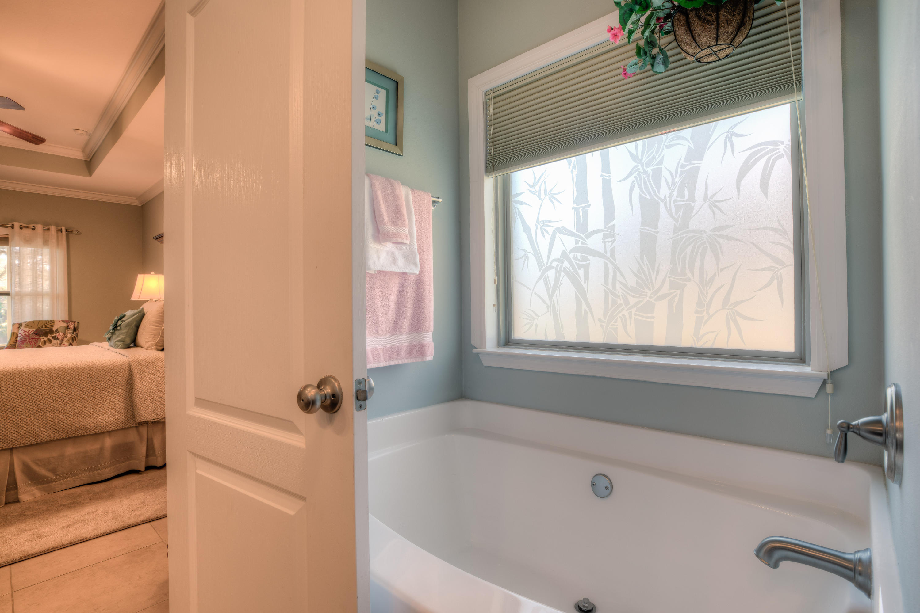 456 Pin Oak Loop Santa Rosa Beach, FL 32459 - Photo 26 of 32 a white bath tub sitting in a bathroom next to a window