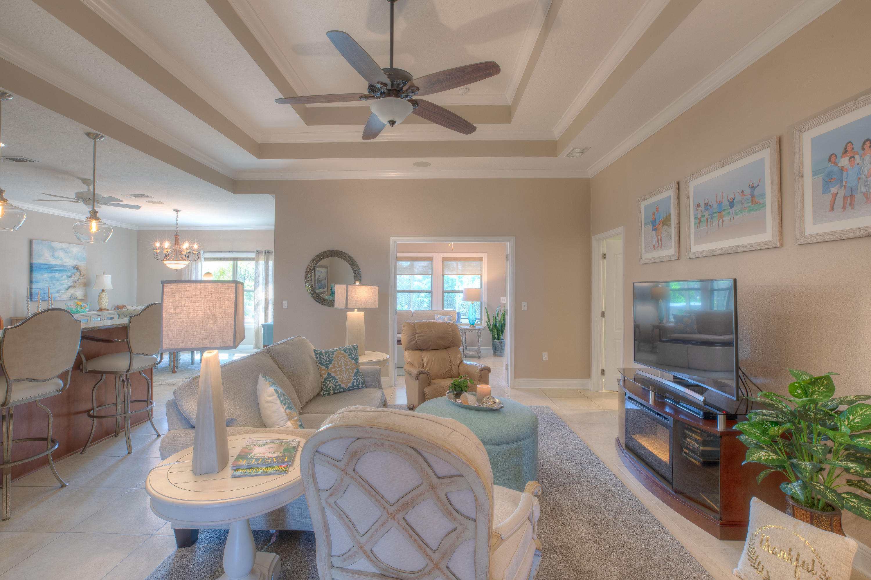 456 Pin Oak Loop Santa Rosa Beach, FL 32459 - Photo 4 of 32 a living room with furniture a chandelier and a flat screen tv