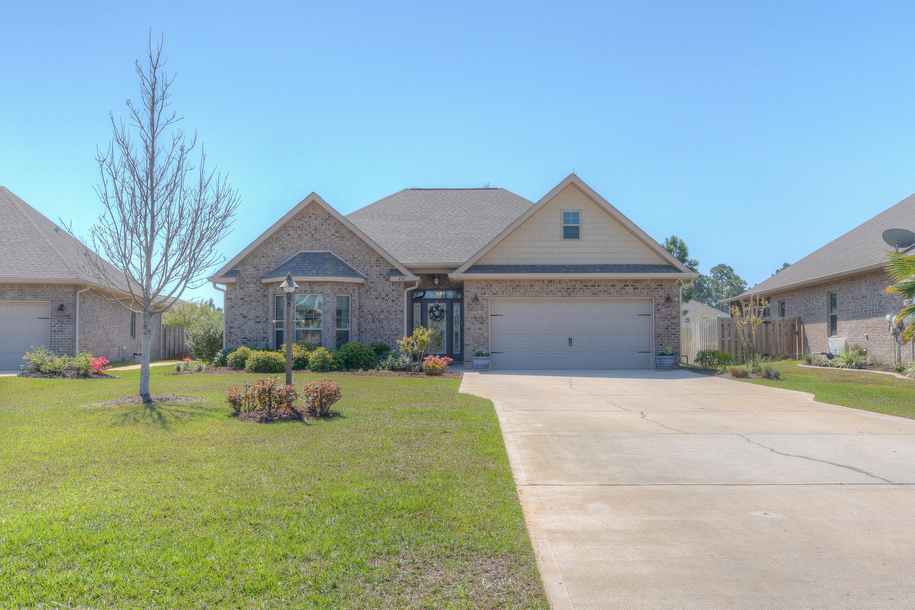456 Pin Oak Loop Santa Rosa Beach, FL 32459 - Photo 5 of 32 a front view of house with yard and trees
