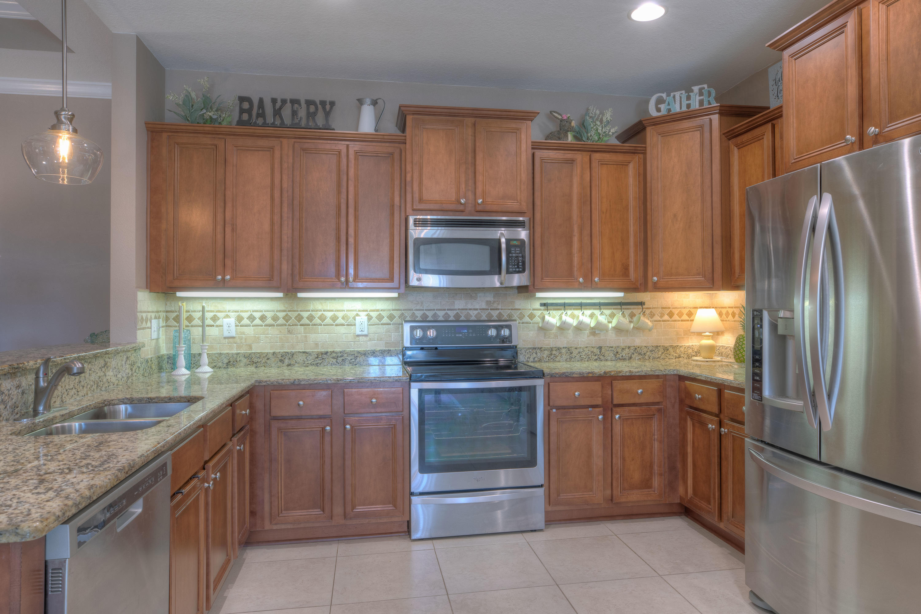 456 Pin Oak Loop Santa Rosa Beach, FL 32459 - Photo 10 of 32 a kitchen with stainless steel appliances granite countertop a refrigerator and a sink