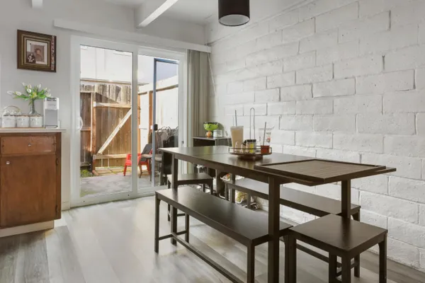 a view of a dining room with furniture window and wooden floor