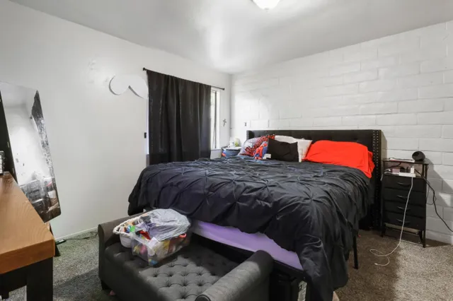 a bedroom with a bed and a window