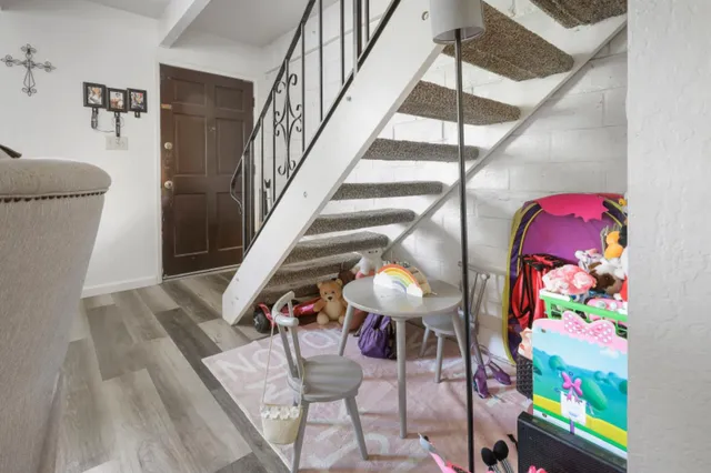 a view of entryway with furniture and wooden floor
