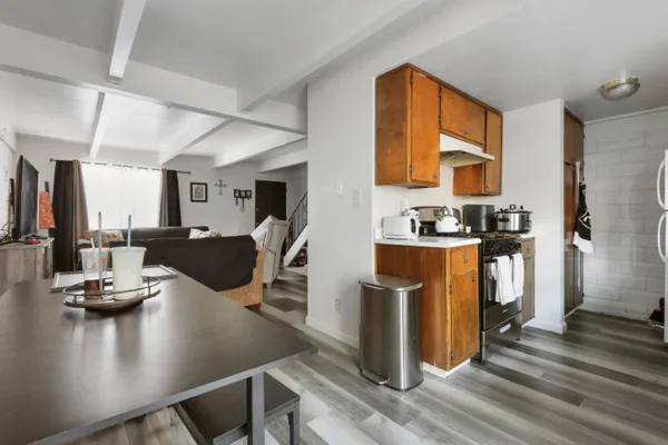 a view of kitchen dining table chairs and refrigerator