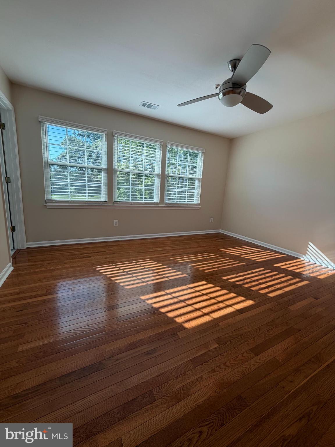 13952 Bishops Bequest Road Upper Marlboro, MD 20772 - Photo 16 of 28 a view of empty room with wooden floor and fan