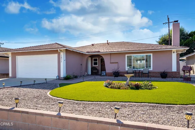 a view of a house with swimming pool and a yard