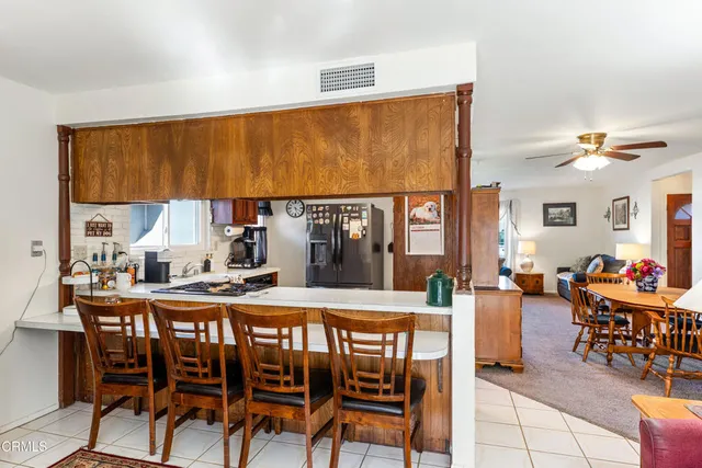 a dining hall with furniture and a large window
