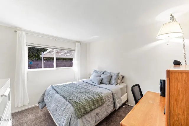 a bedroom with bed and window