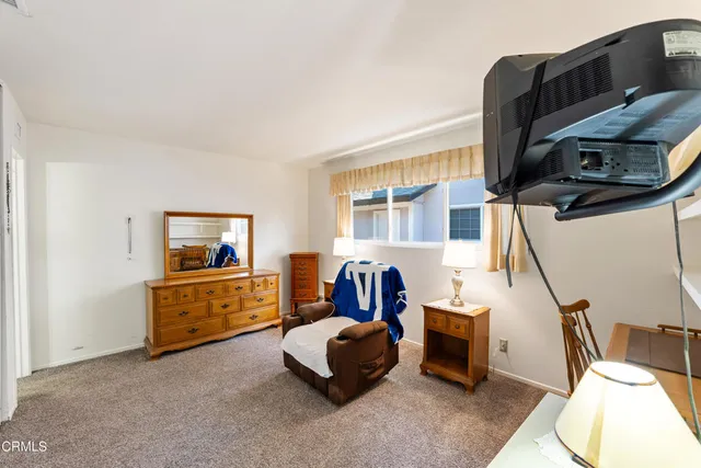 a bedroom with furniture and a window