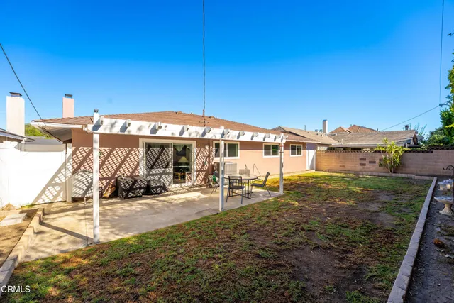 a view of a house with backyard porch and sitting area