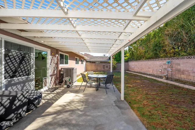 a view of a patio with table and chairs potted plants with wooden floor