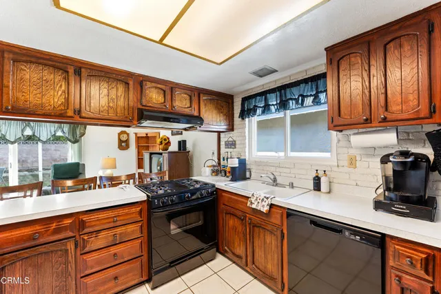 a kitchen with stainless steel appliances granite countertop a stove sink and cabinets