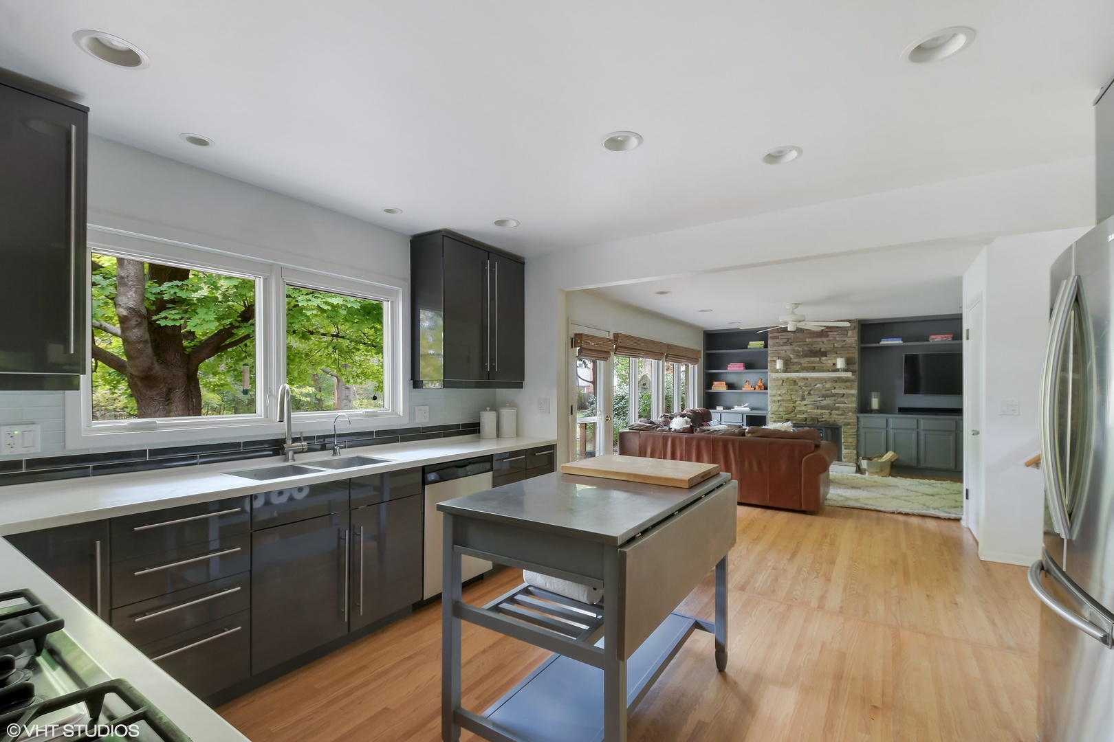 208 Sunset Terrace Lake Bluff, IL 60044 - Photo 8 of 14 a kitchen with a sink a counter top space and living room area