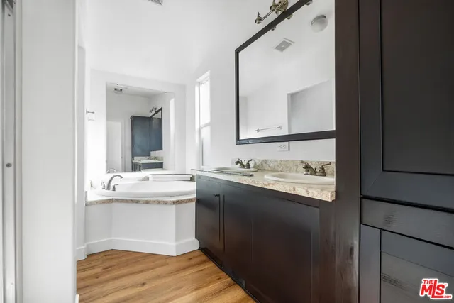 a bathroom with a granite countertop sink and a mirror