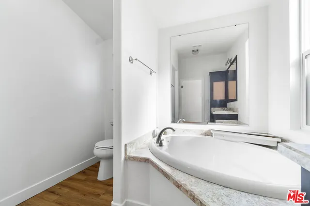 a white bath tub sitting next to a white sink