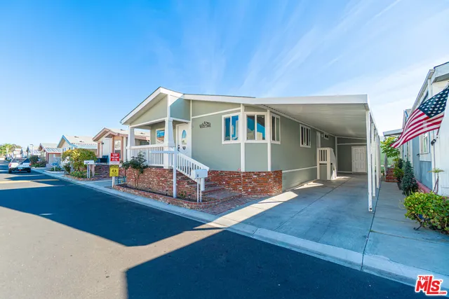 a front view of house with yard outdoor seating and barbeque oven