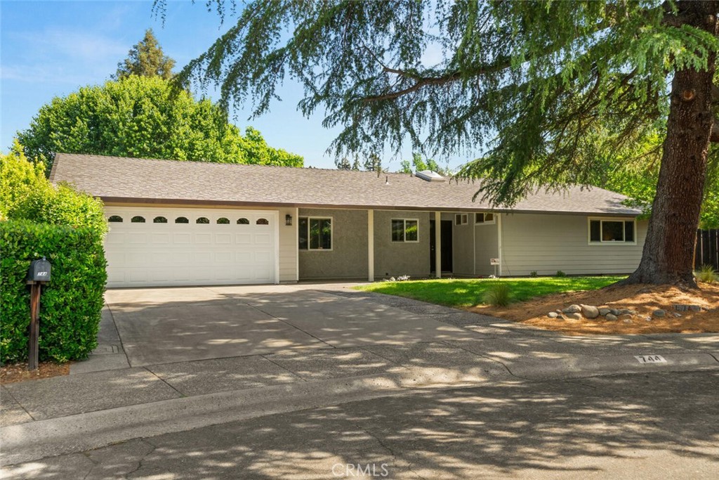 a front view of a house with a yard and a garage