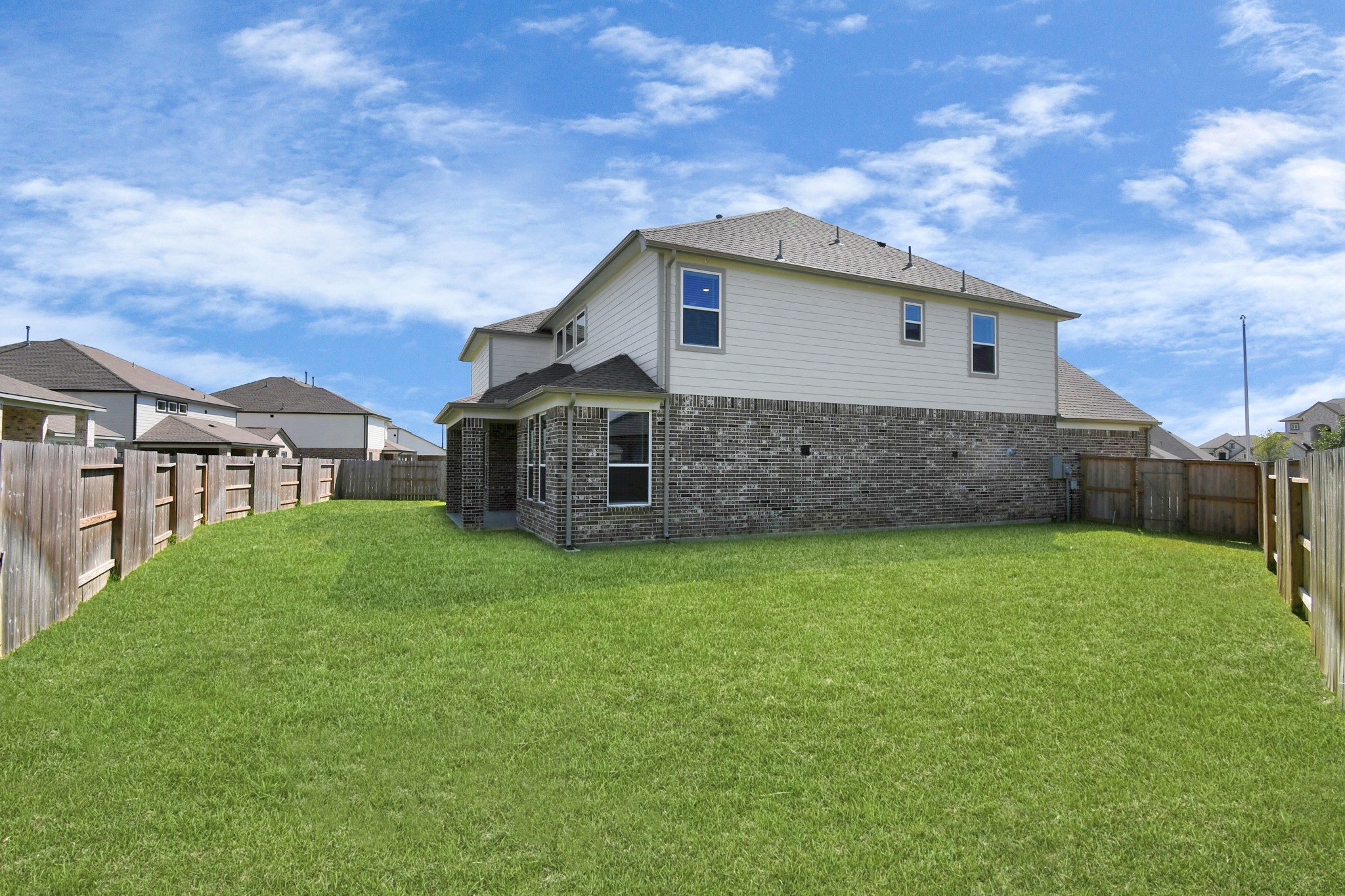 3106 Native Spg Drive Spring, TX 77373 - Photo 38 of 38 Explore the expansive backyard with its inviting covered patio—a perfect blend of space for the kids to play and adults to unwind. Ideal for creating your outdoor oasis, this backyard accommodates patio furniture, a BBQ pit, and endless possibilities for leisure and entertainment. Sample photo of completed home with similar floor plan. Actual colors and selections may vary.