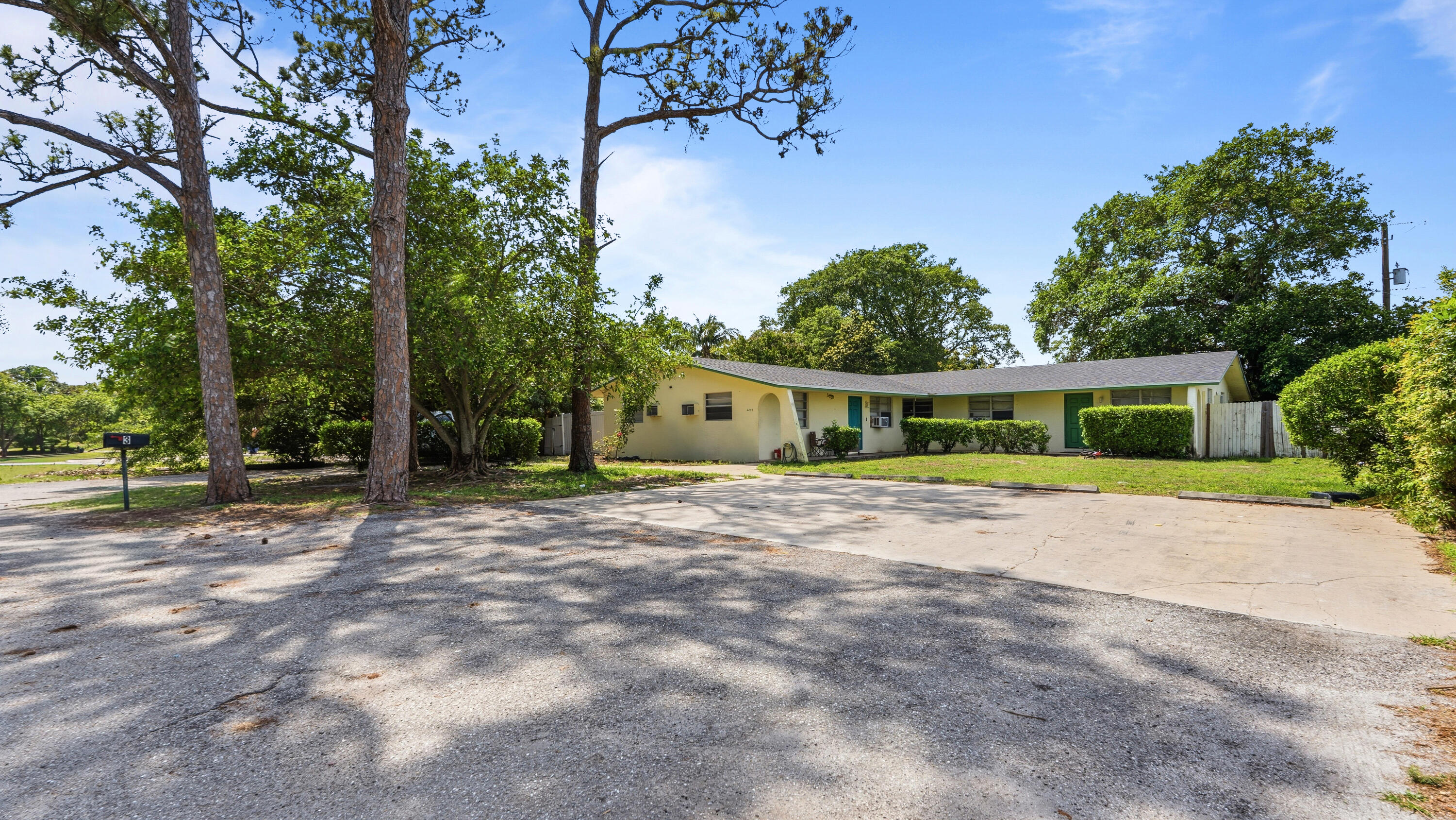 4453 Stevens Road Lake Worth Beach, FL 33461 - Photo 22 of 67 a front view of a house with a garden