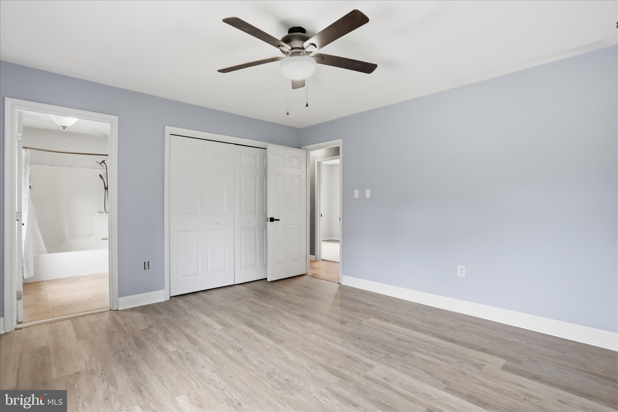 13733 Barnhart Road Clear Spring, MD 21722 - Photo 11 of 32 an empty room with wooden floor and ceiling fan