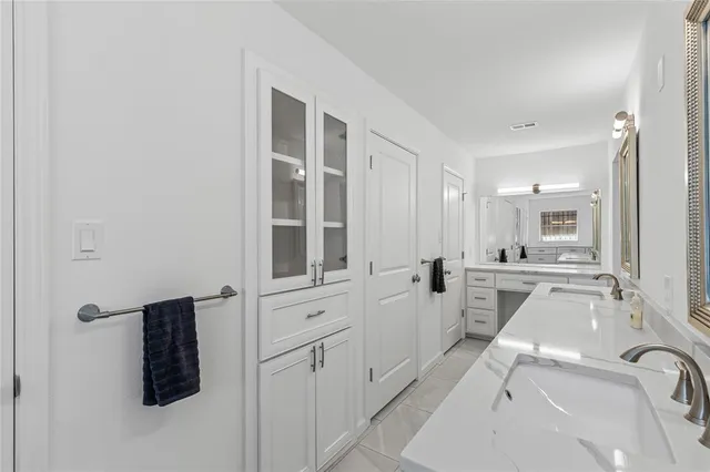 a bathroom with a tub sink and mirror