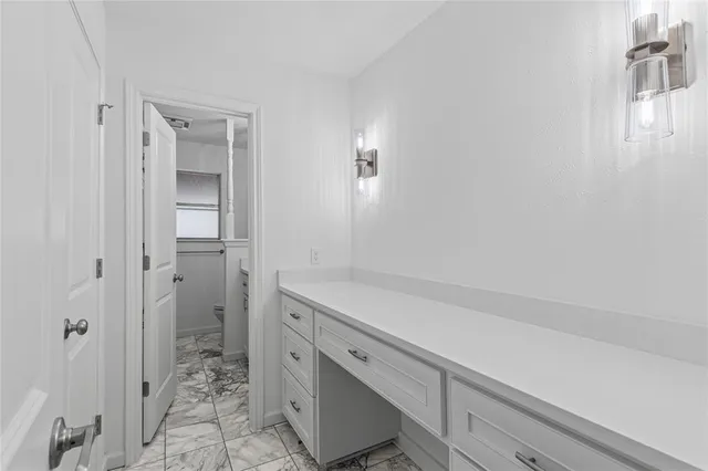 a bathroom with a shower and a sink