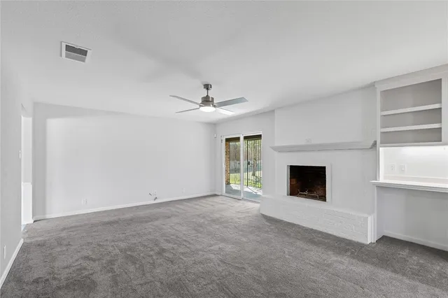 a view of empty room with a fireplace