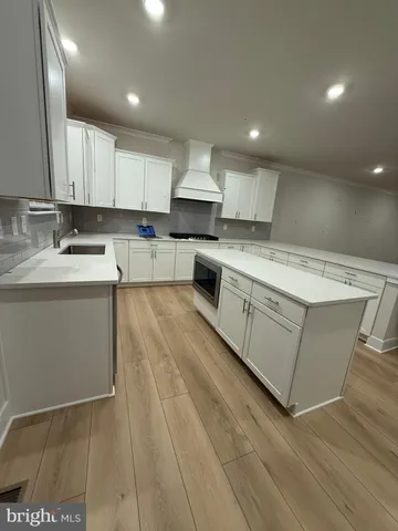 a kitchen with stainless steel appliances granite countertop a sink counter space cabinets and a large window