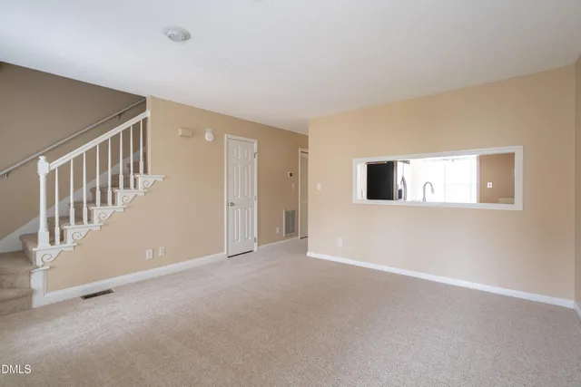 a view of an empty room with windows