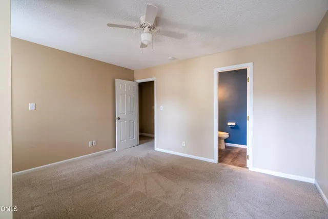 a view of an empty room with a ceiling fan