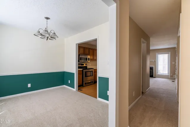 a view of a room with a furniture and a ceiling fan