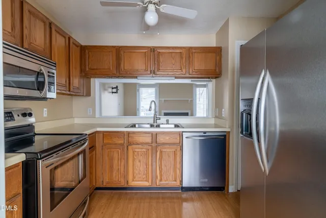 a kitchen with stainless steel appliances granite countertop a stove top oven a sink and dishwasher