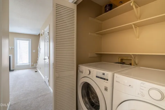 a view of storage and utility room with washer and dryer