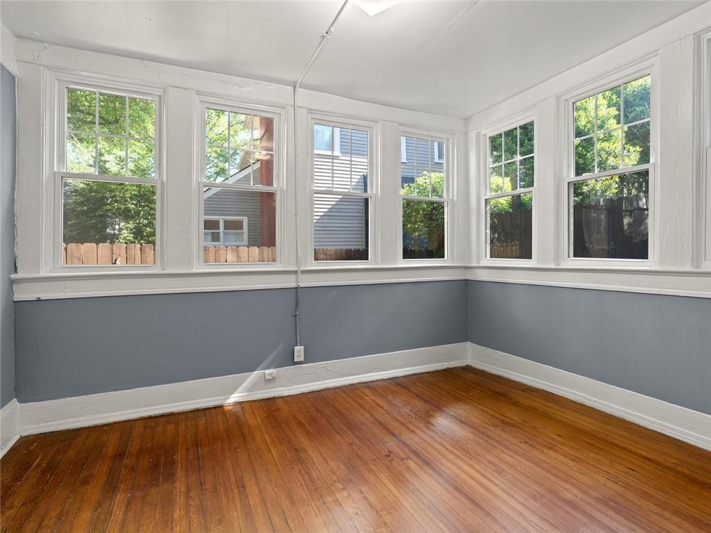 164 4th Street Northeast, Unit 9 Atlanta, GA 30308 - Photo 2 of 18 a view of a room with wooden floor and a window