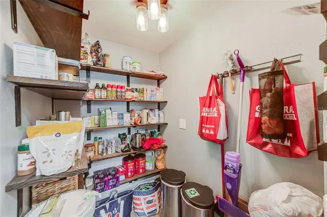 a view of a livingroom with wooden floor and a ceiling fan