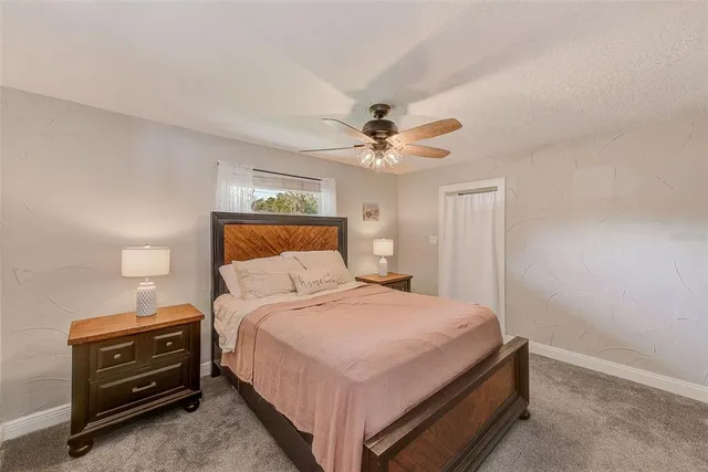 a bedroom with a large bed and a chandelier