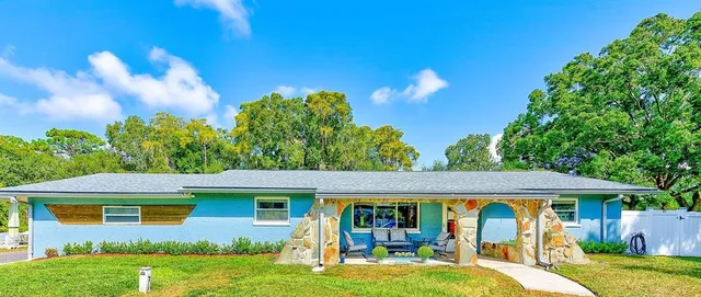 a view of a house with backyard garden and swimming pool