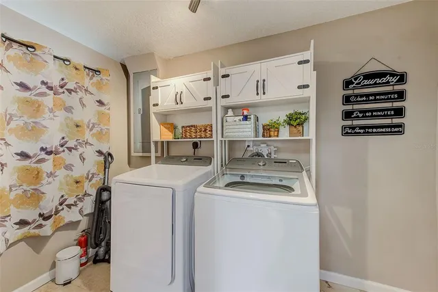 a view of an swimming pool with a chair and table in the patio