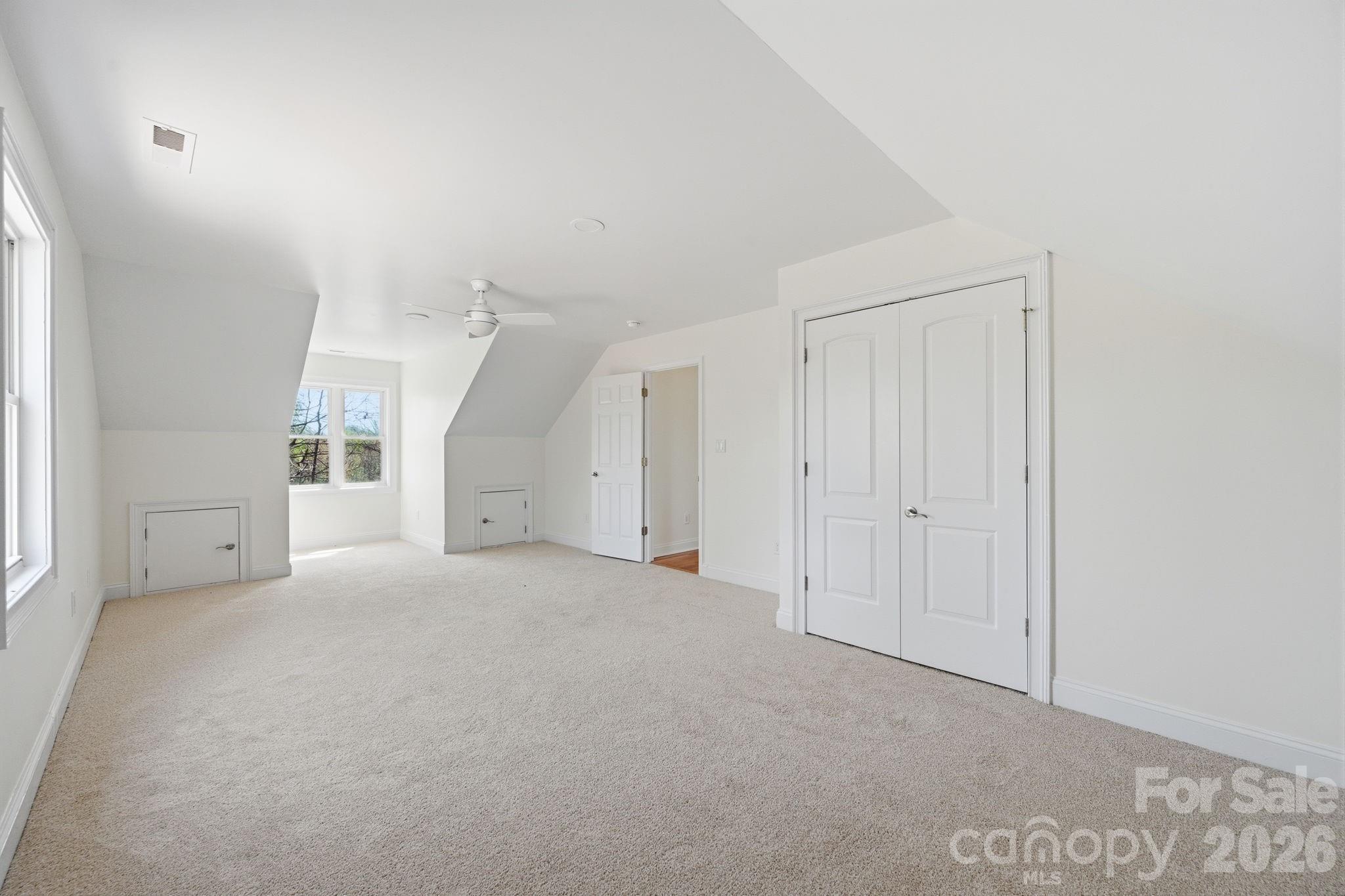 166 Ridge Run Drive Statesville, NC 28625 - Photo 17 of 19 an empty room with windows and entrance to other room