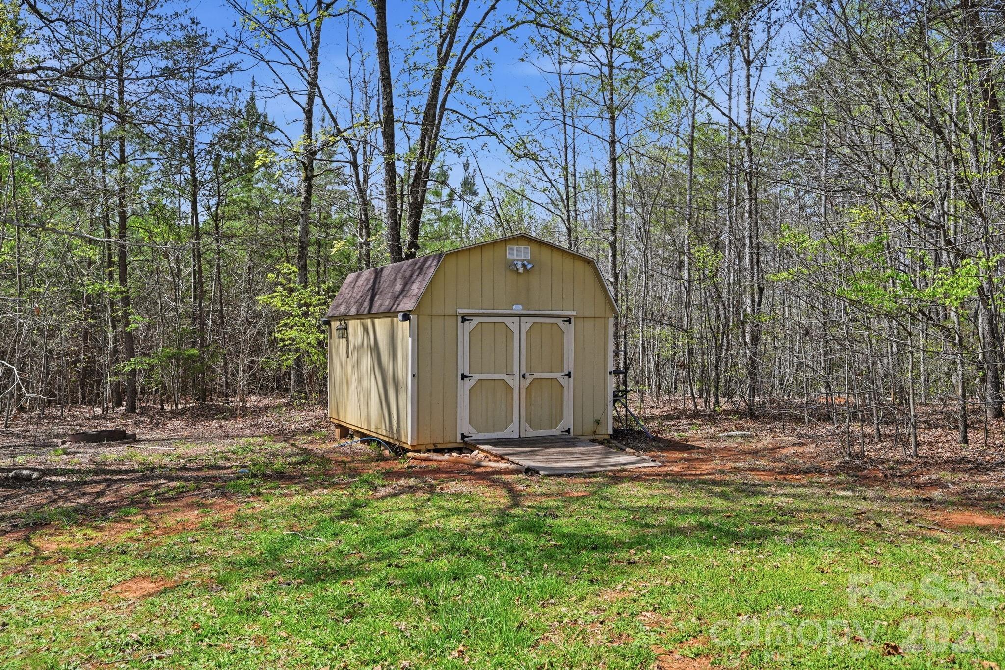 166 Ridge Run Drive Statesville, NC 28625 - Photo 18 of 19 a view of a tiny house with a yard