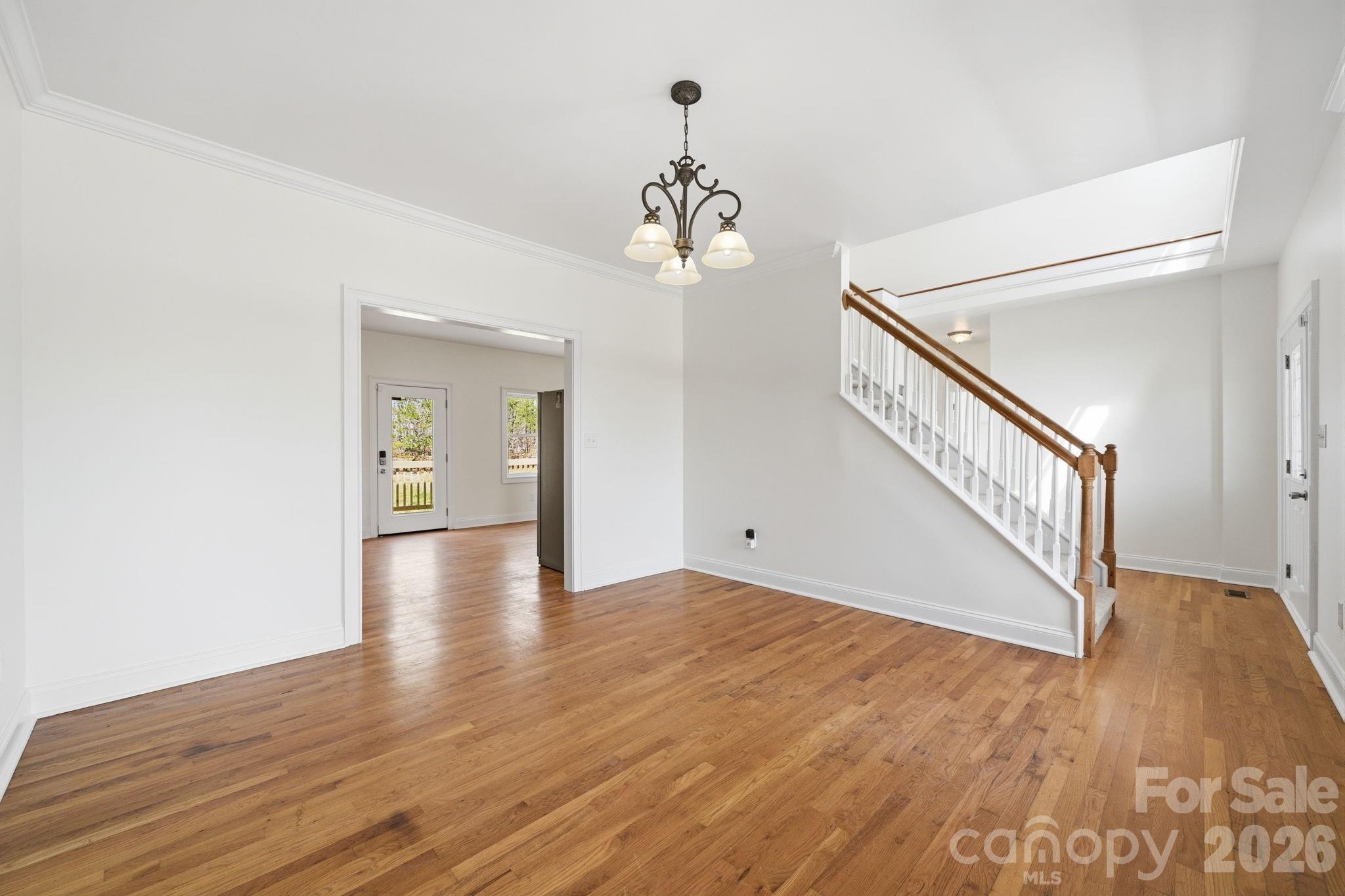 166 Ridge Run Drive Statesville, NC 28625 - Photo 3 of 19 a view of a hallway with wooden floor and staircase
