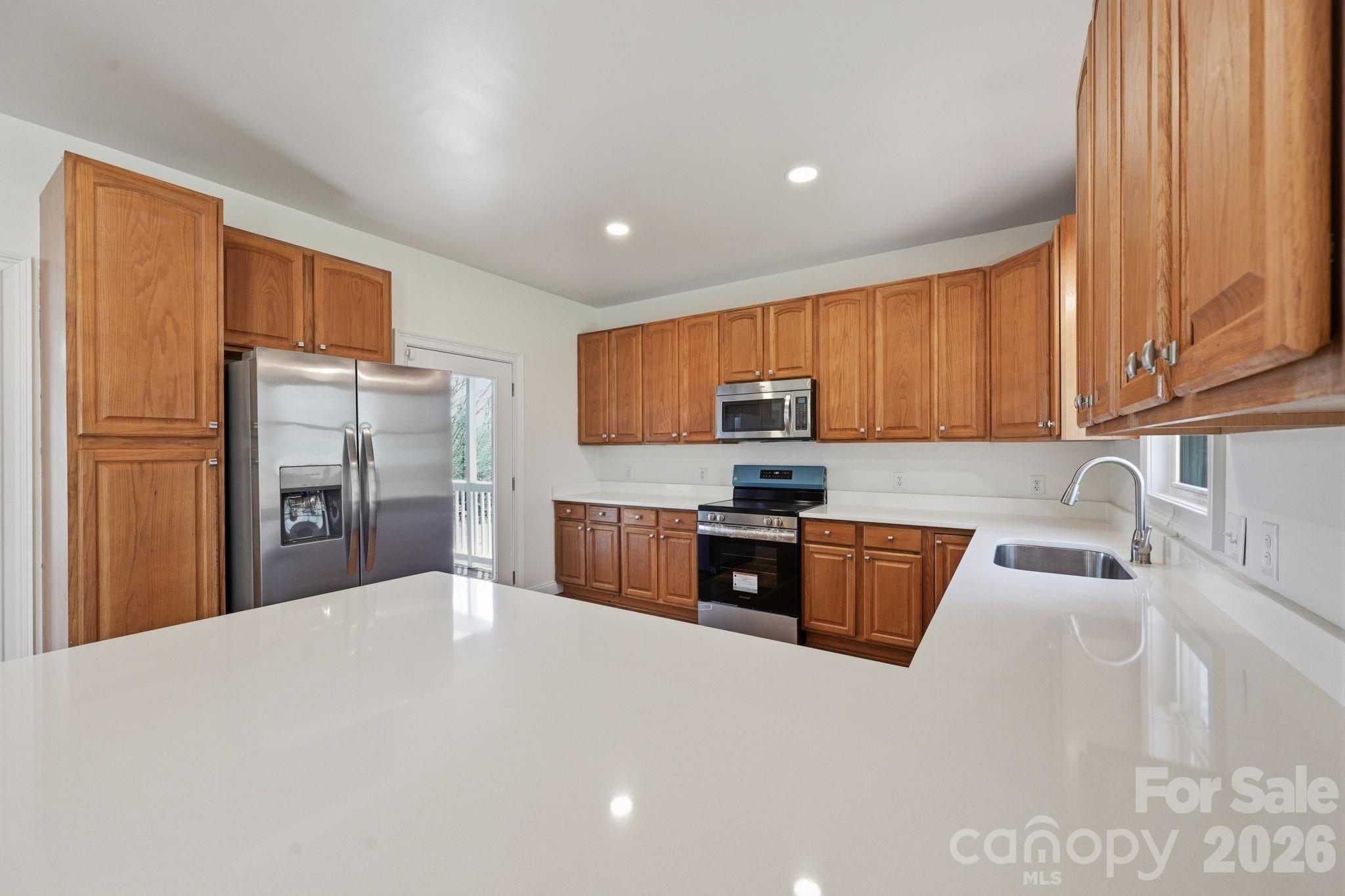 166 Ridge Run Drive Statesville, NC 28625 - Photo 5 of 19 a kitchen with stainless steel appliances granite countertop a refrigerator sink and stove