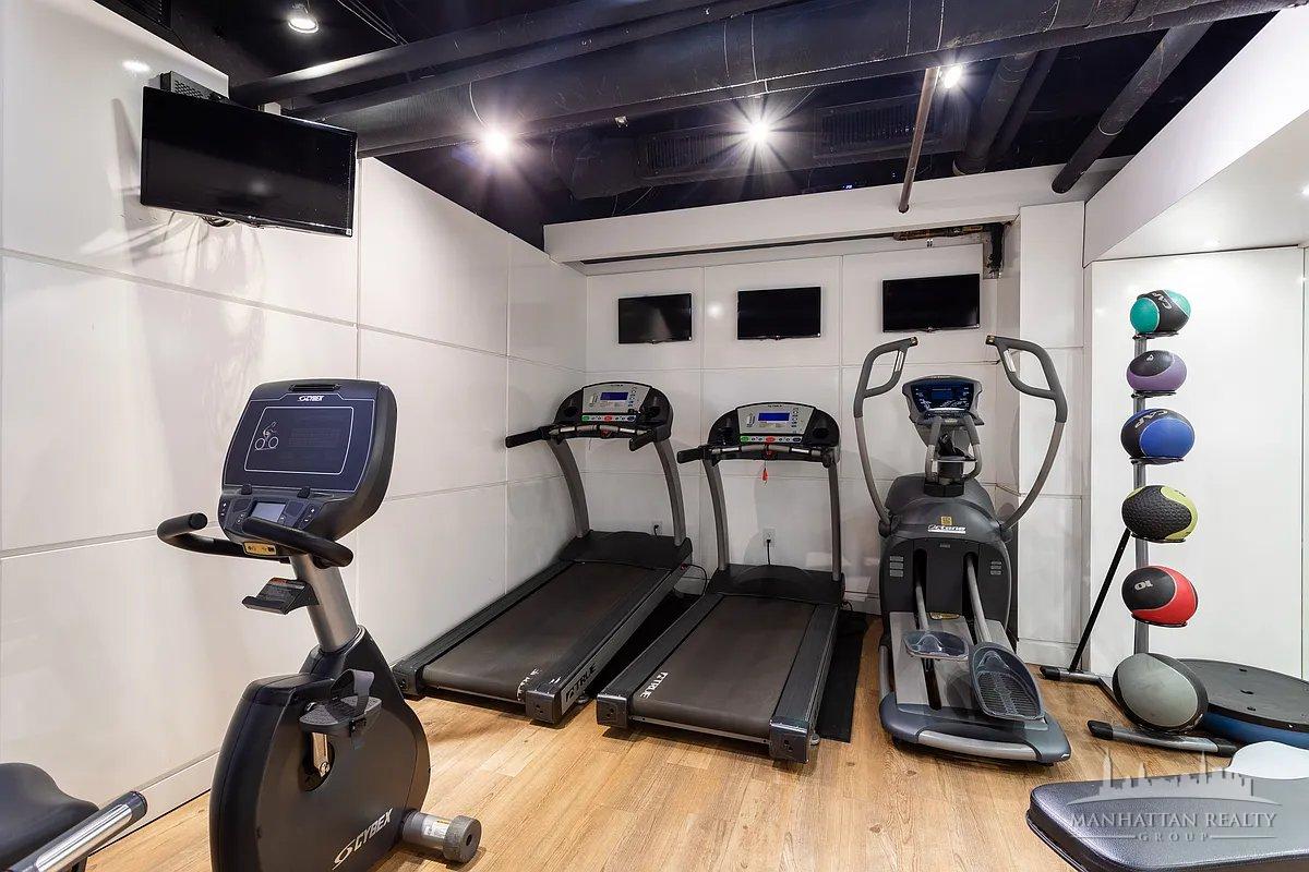 220 East 63rd Street, Unit 8J Manhattan, NY 10023 - Photo 12 of 14 a view of a room with gym equipment
