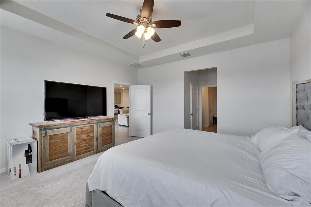 5125 Tannin Lane Lakewood Ranch, FL 34211 - Photo 12 of 45 a bedroom with a bed and a flat screen tv