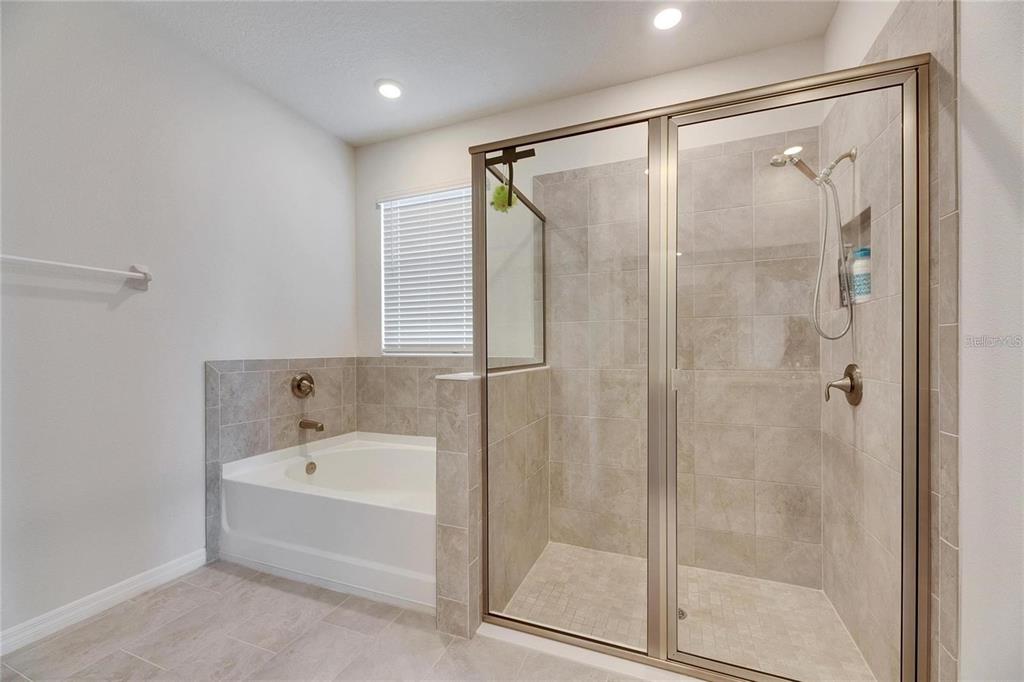 5125 Tannin Lane Lakewood Ranch, FL 34211 - Photo 17 of 45 a bathroom with a bathtub and a shower