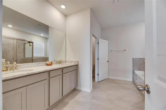 a bathroom with a double vanity sink and mirror